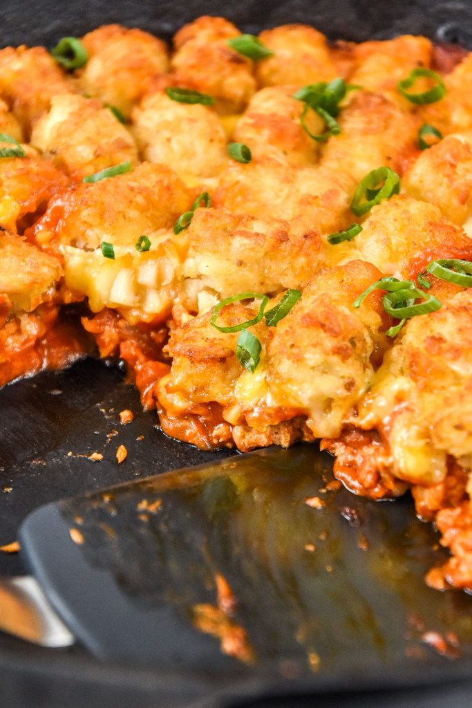 interior of the turkey sloppy joe tater tot casserole in a cast iron skillet.