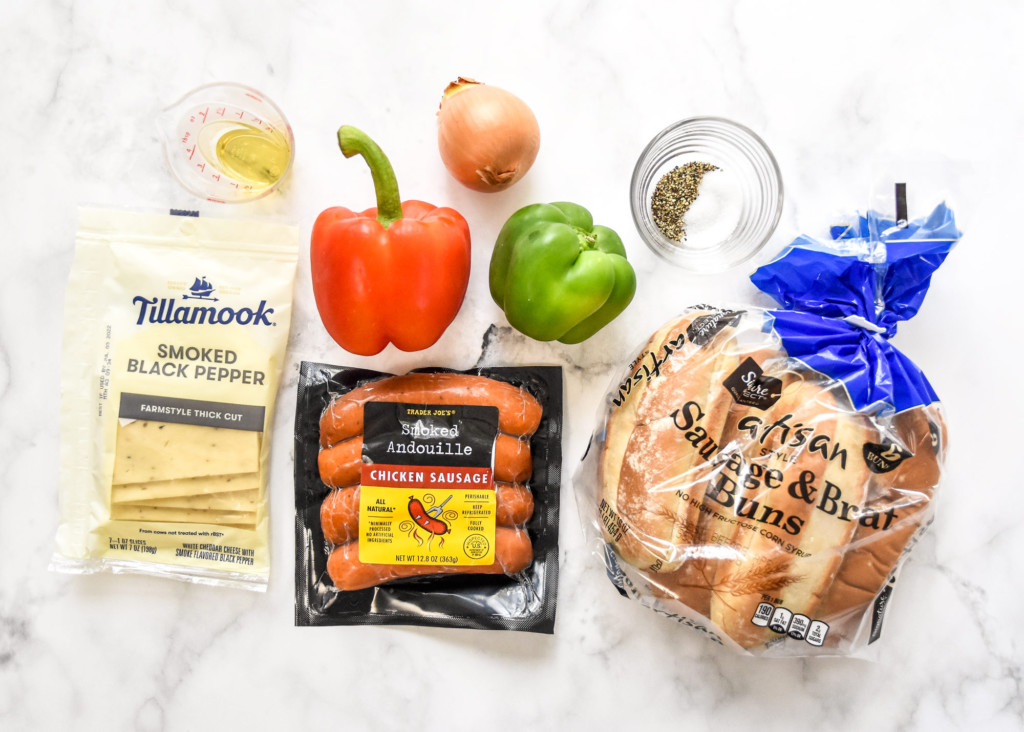 ingredients for the air fryer sausage dogs with peppers and onions before cooking.