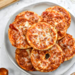 stack of just cooked air fryer homemade pizza bagel bites on a plate.