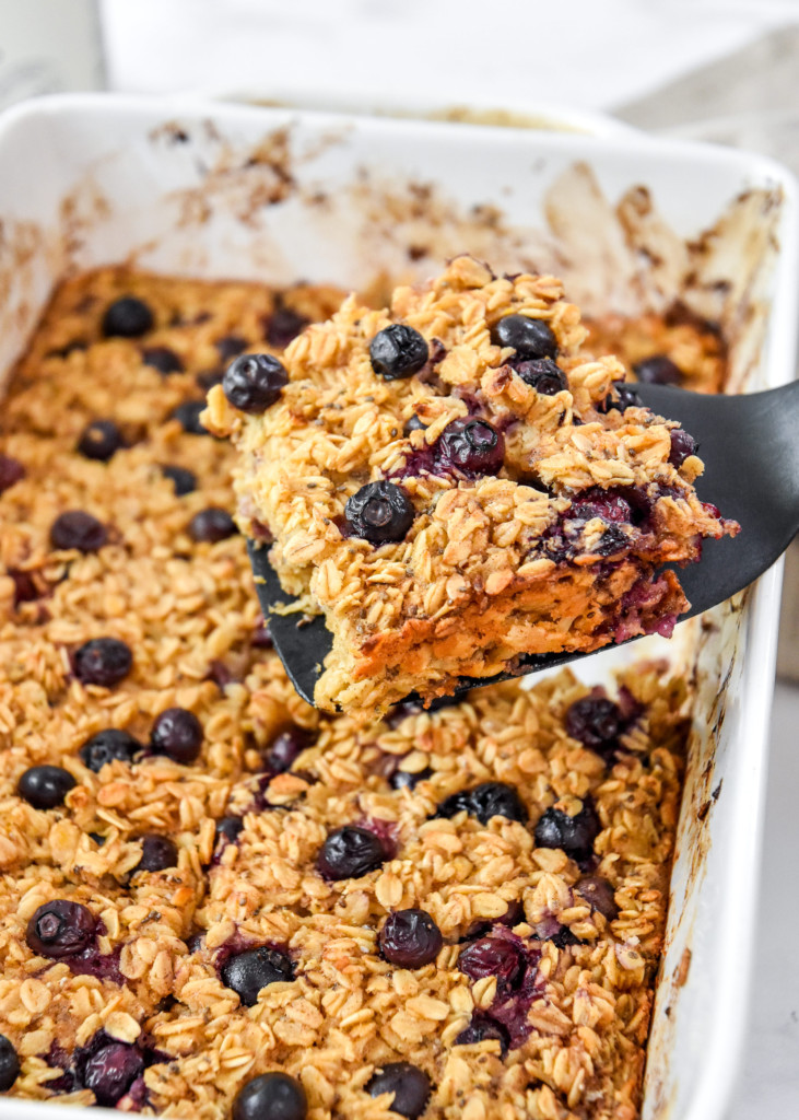 serving a portion of easy blueberry lemon baked oatmeal on a spatula.