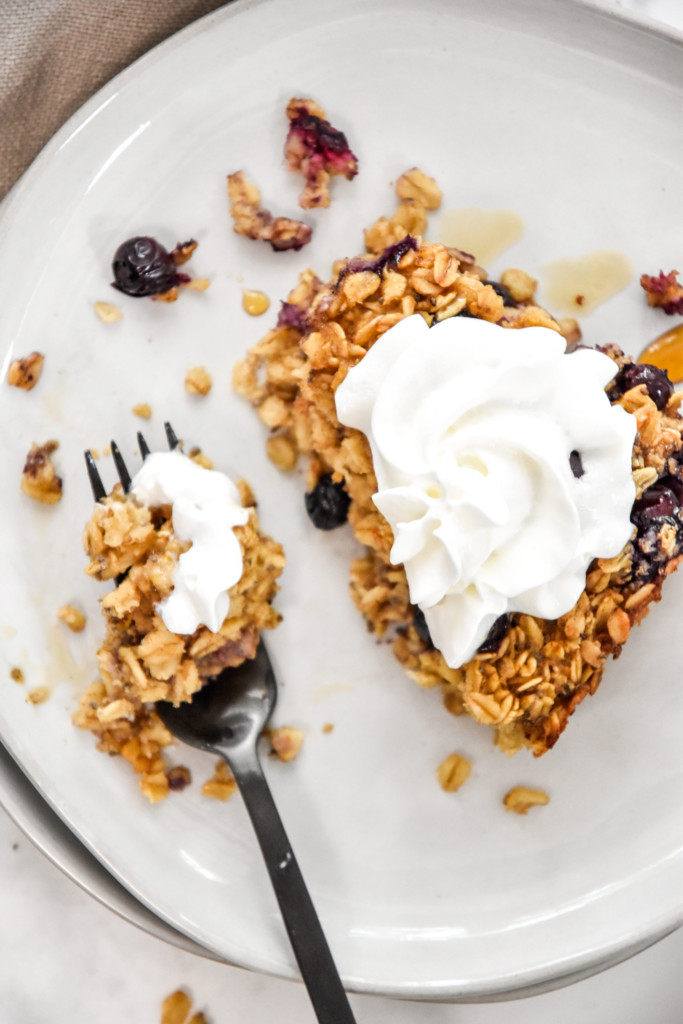 whipped cream on a serving of easy blueberry lemon baked oatmeal.