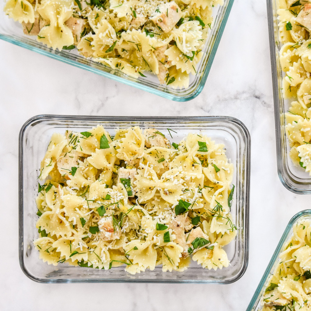 herby lemon chicken pasta salad in glass meal prep bowls.