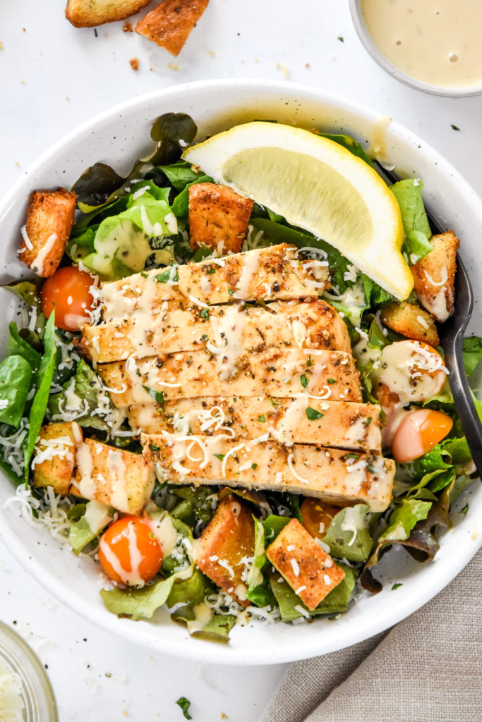 juicy air fryer boneless chicken breasts on a caesar salad.