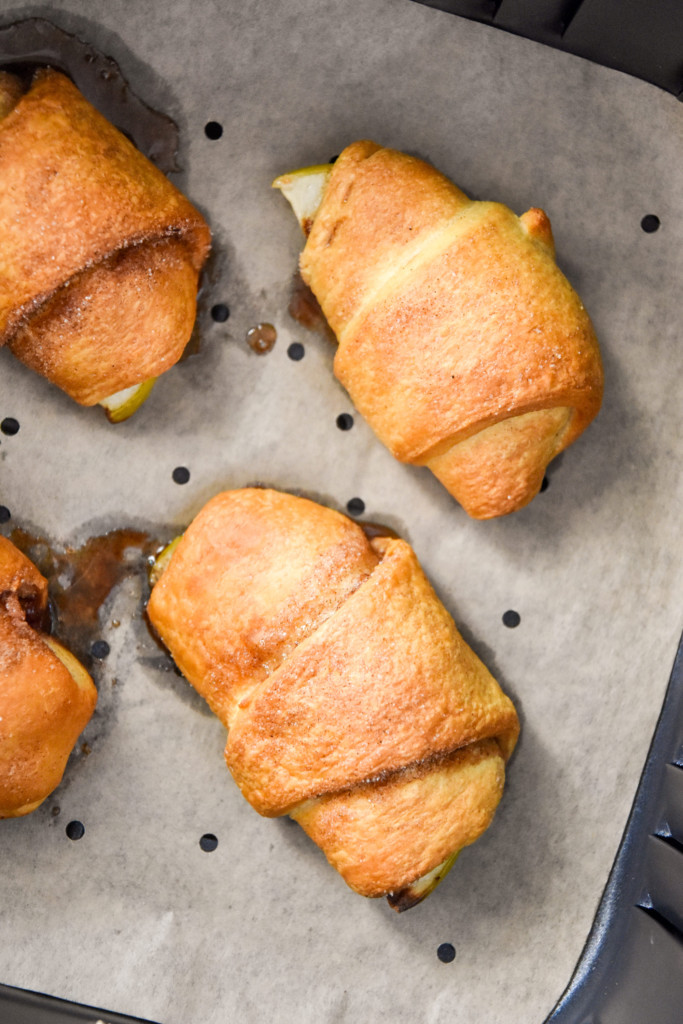 close up of cooked apple pie crescent rolls in the air fryer.