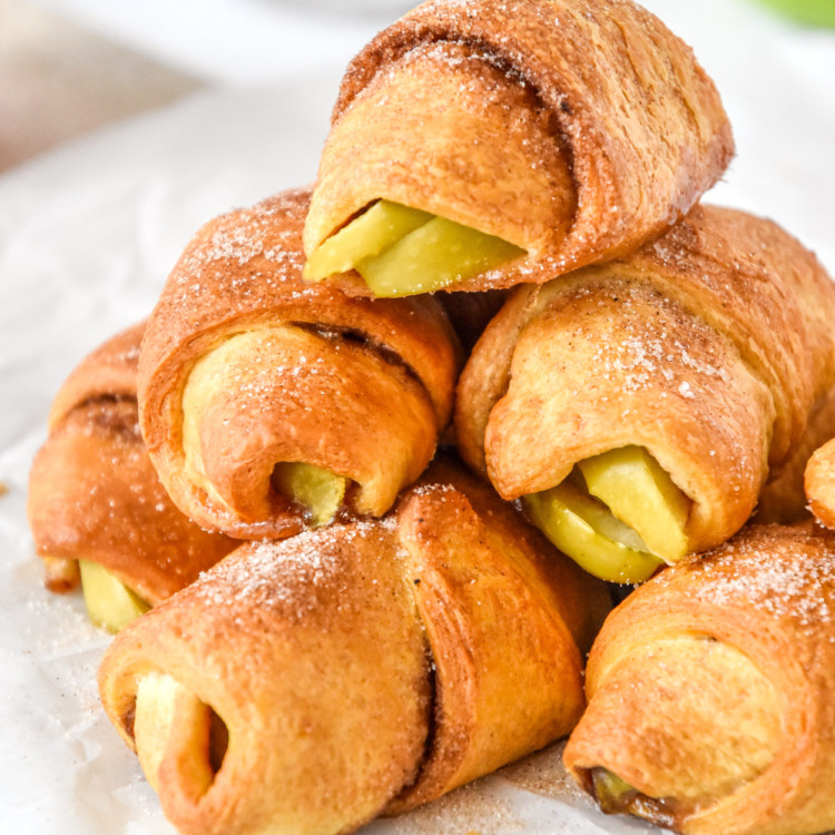 stack of air fryer apple pie crescent rolls with cinnamon sugar on top.