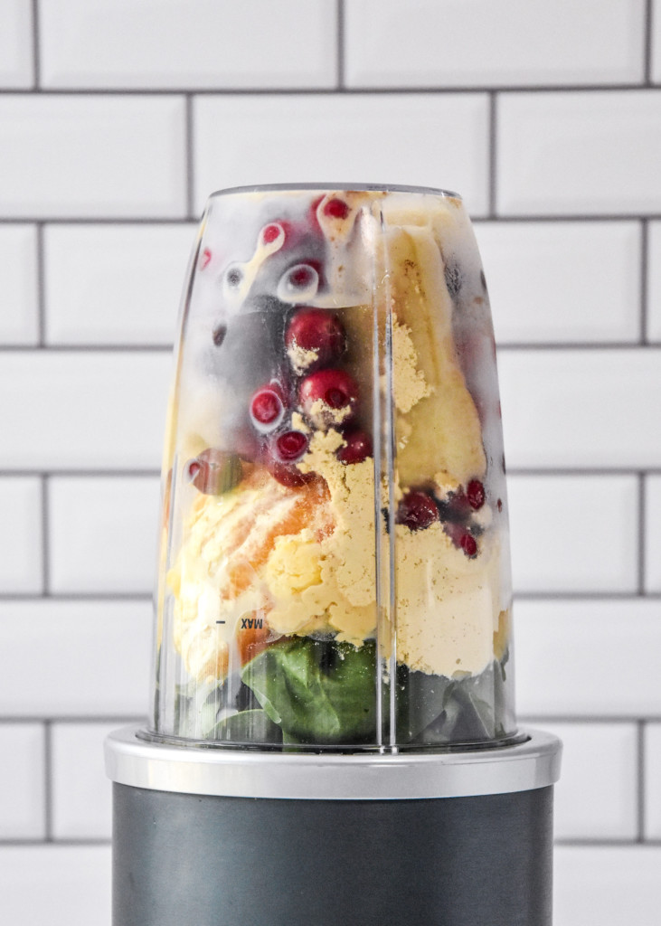 ingredients in the blender before blending up the smoothie in a nutribullet.