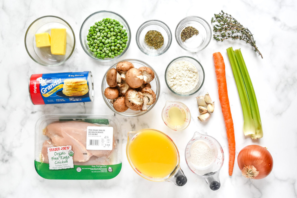 ingredients on a marble table for cooking the chicken pot pie with biscuit crust.