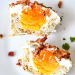 tater tot crust baked egg cups cut in half on a white plate.