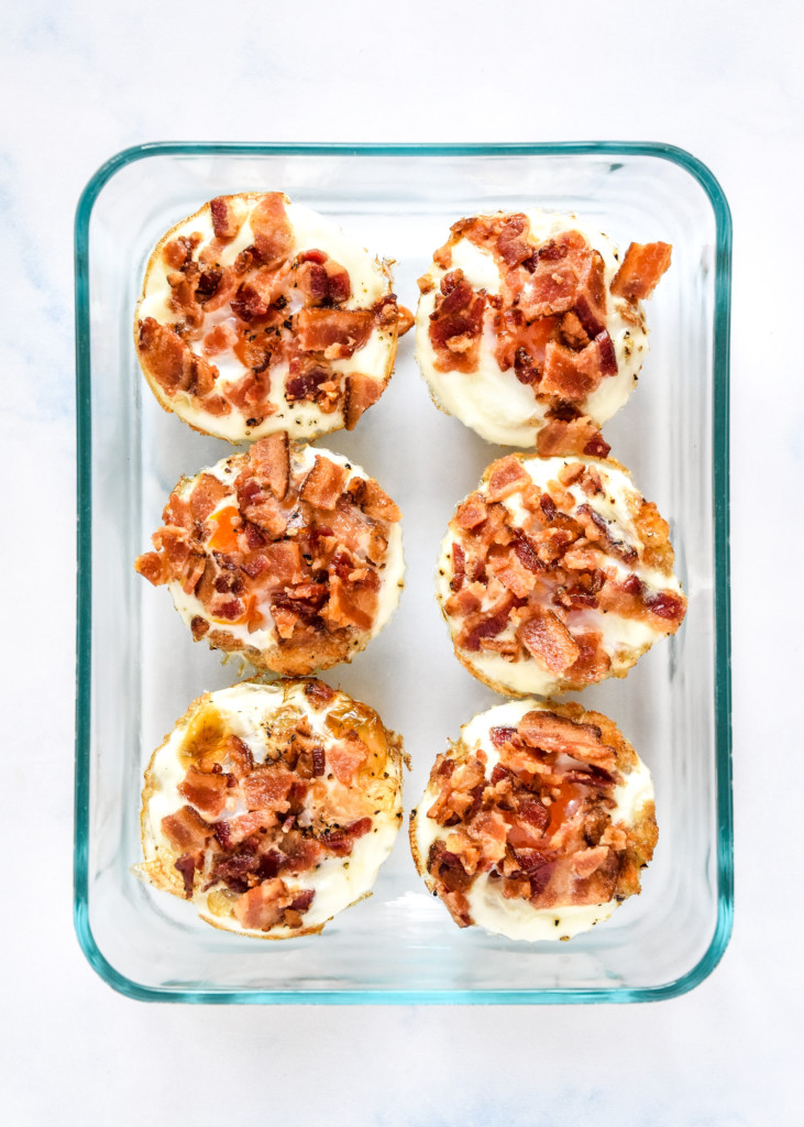 tater tot crust baked egg cups in a glass meal prep container.
