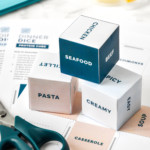 the dinner dice assembled stacked with scissors and tape.