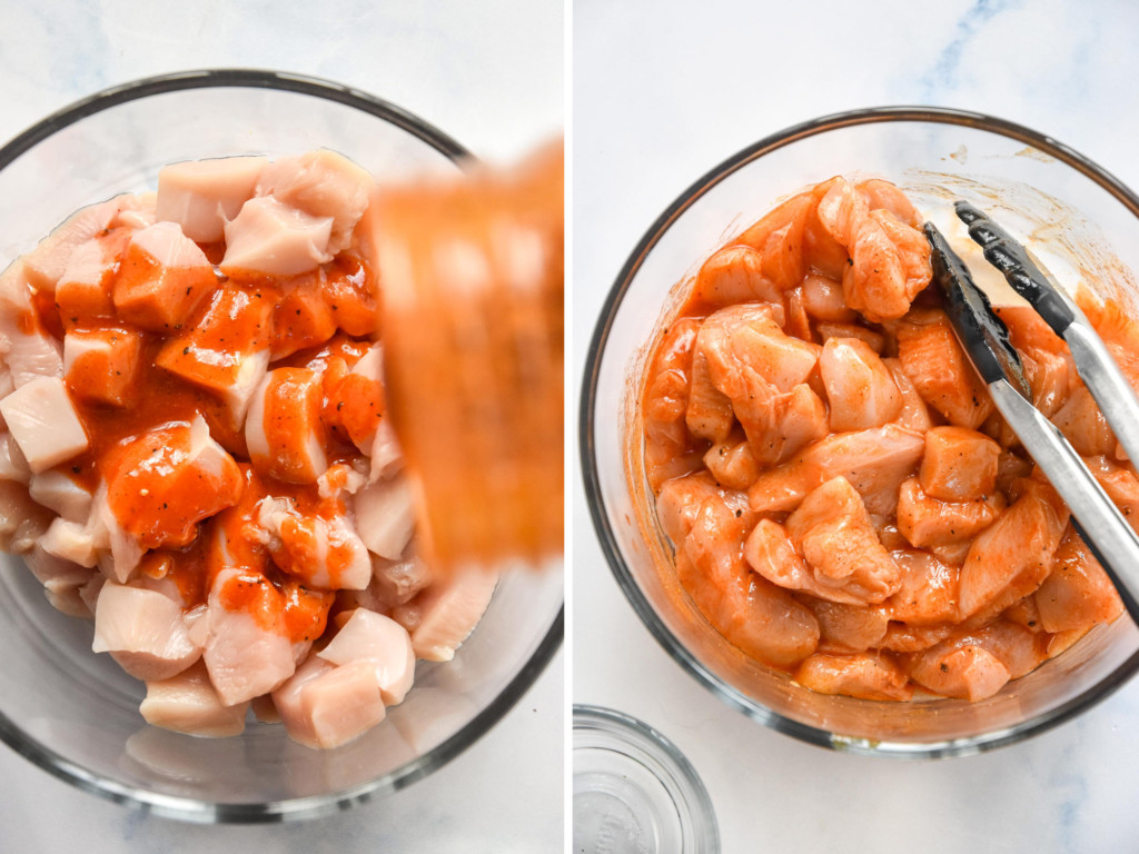 drizzling sauce on to the raw chicken pieces for the buffalo chicken and broccoli meal prep.