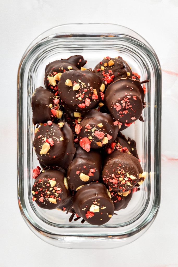 chocolate covered PB&J banana bites in a glass meal prep container.