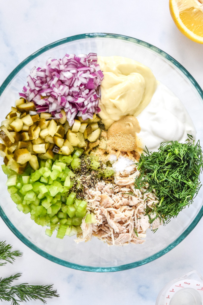 all ingredients for the dill pickle chicken salad in a large glass mixing bowl.