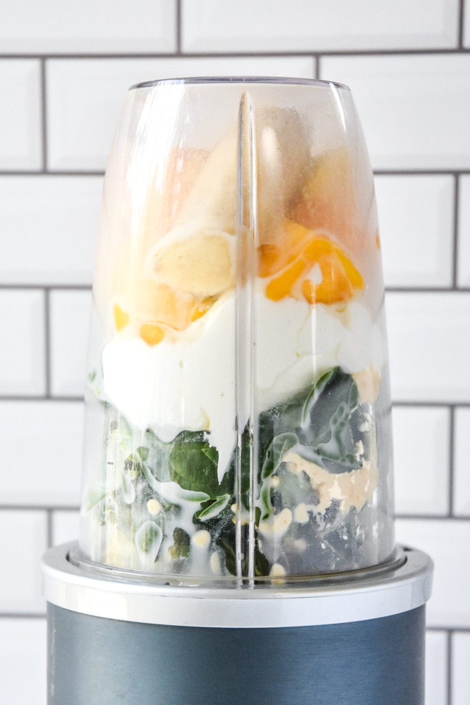 everything in the blender before blending up the creamy avocado mint green smoothie.