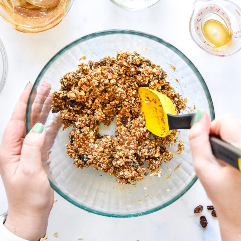 no-bake oatmeal raisin cookie balls mixture stirred together with a large spoon.