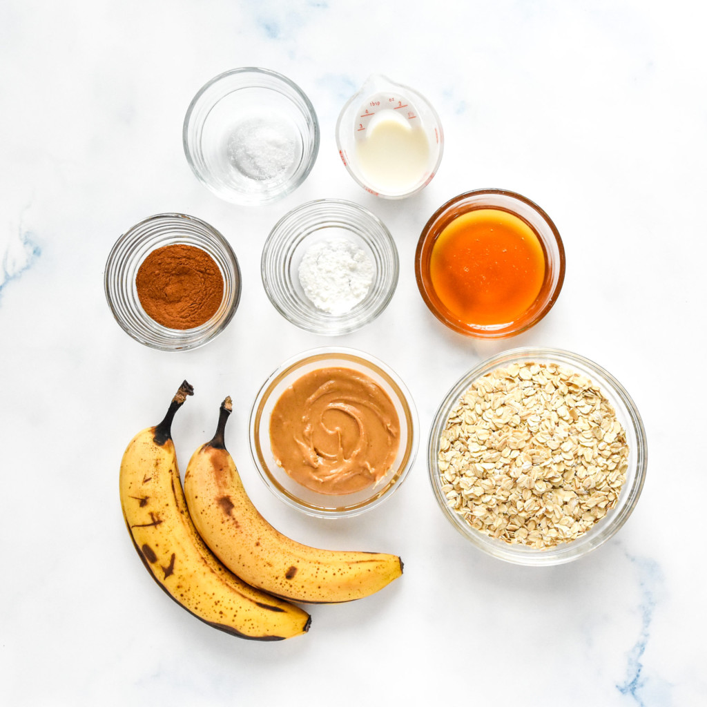 ingredients in glass bowls needed to make the pb oatmeal bars.