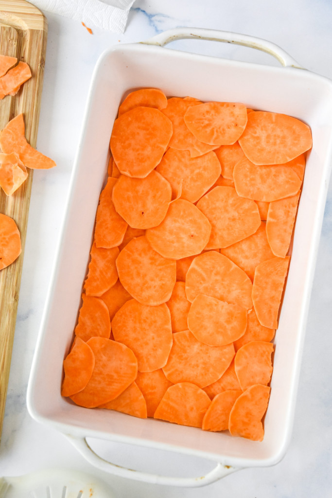sweet potato layers arranged in a casserole dish for the breakfast casserole crust.