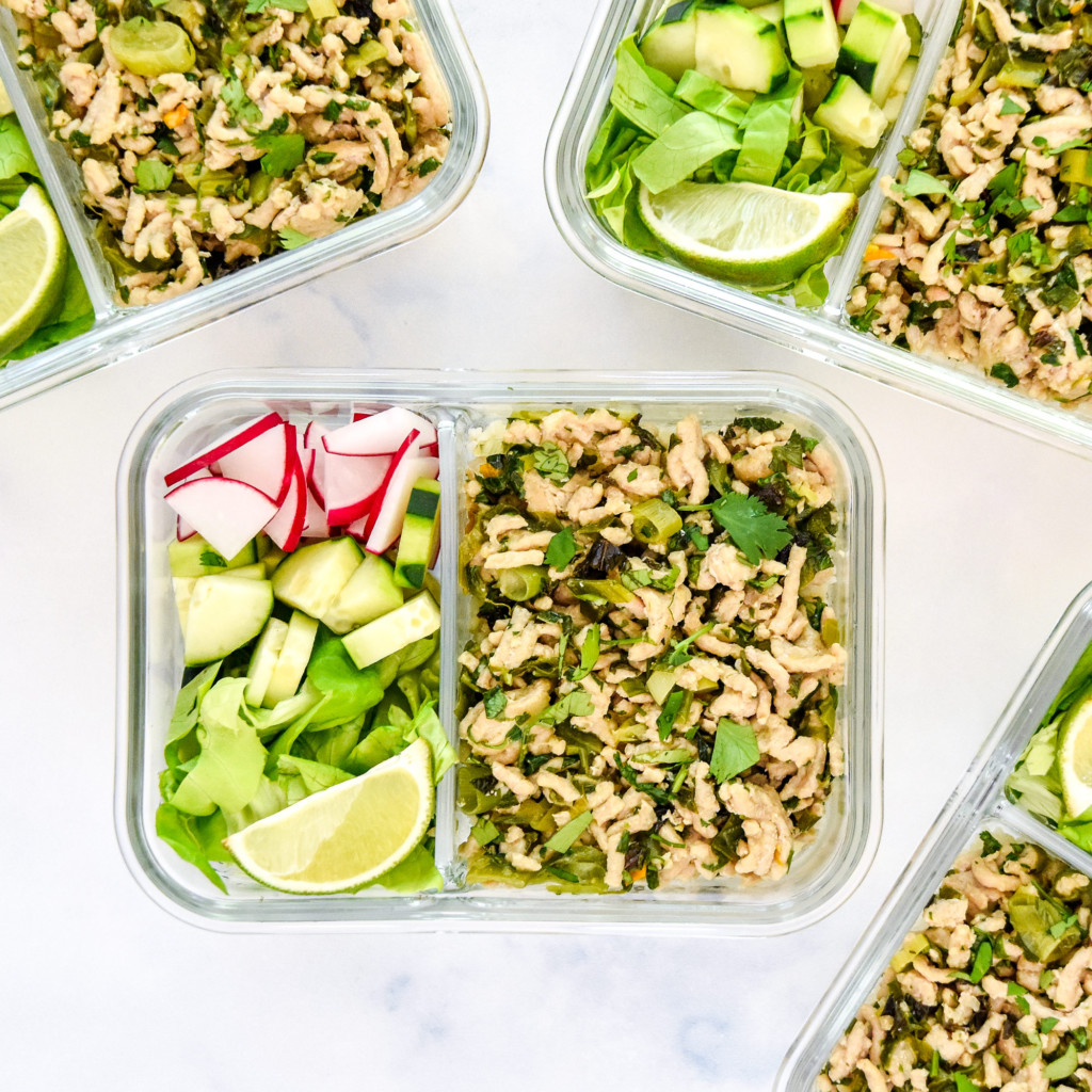 thai chicken larb inspired meal prep in a glass container with veggies.