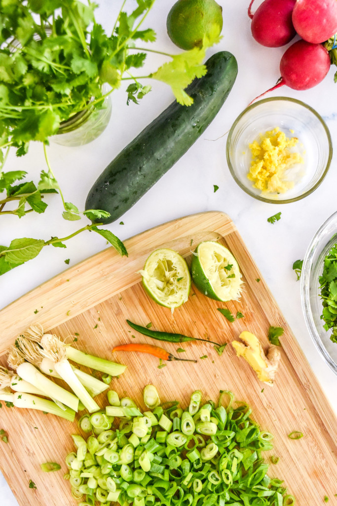 prepping and chopping all ingredients on a cutting board.