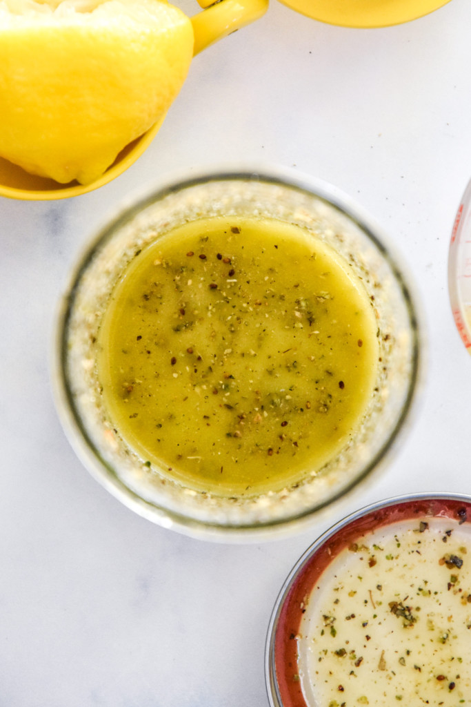 making the lemon italian dressing in a glass mason jar.