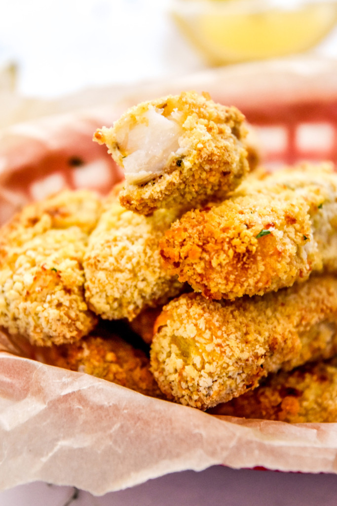stacked fish sticks with one on top open so you can see the fish inside.