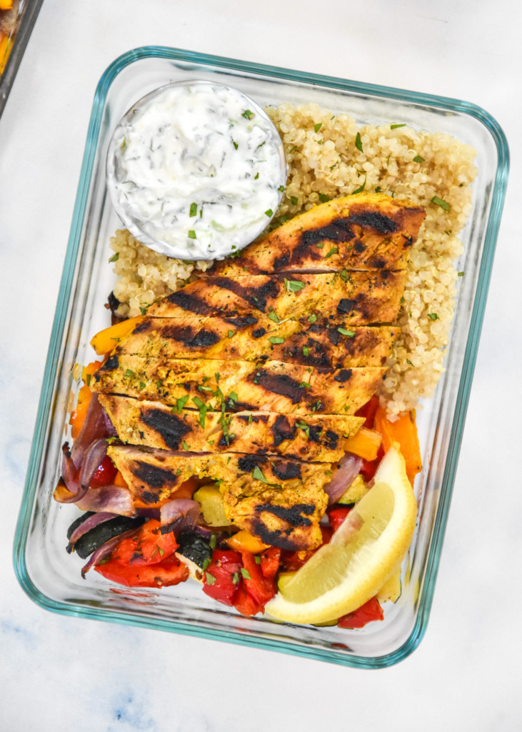 close up of a portion of indian-inspired spiced chicken meal prep in a rectangular pyrex bowl.
