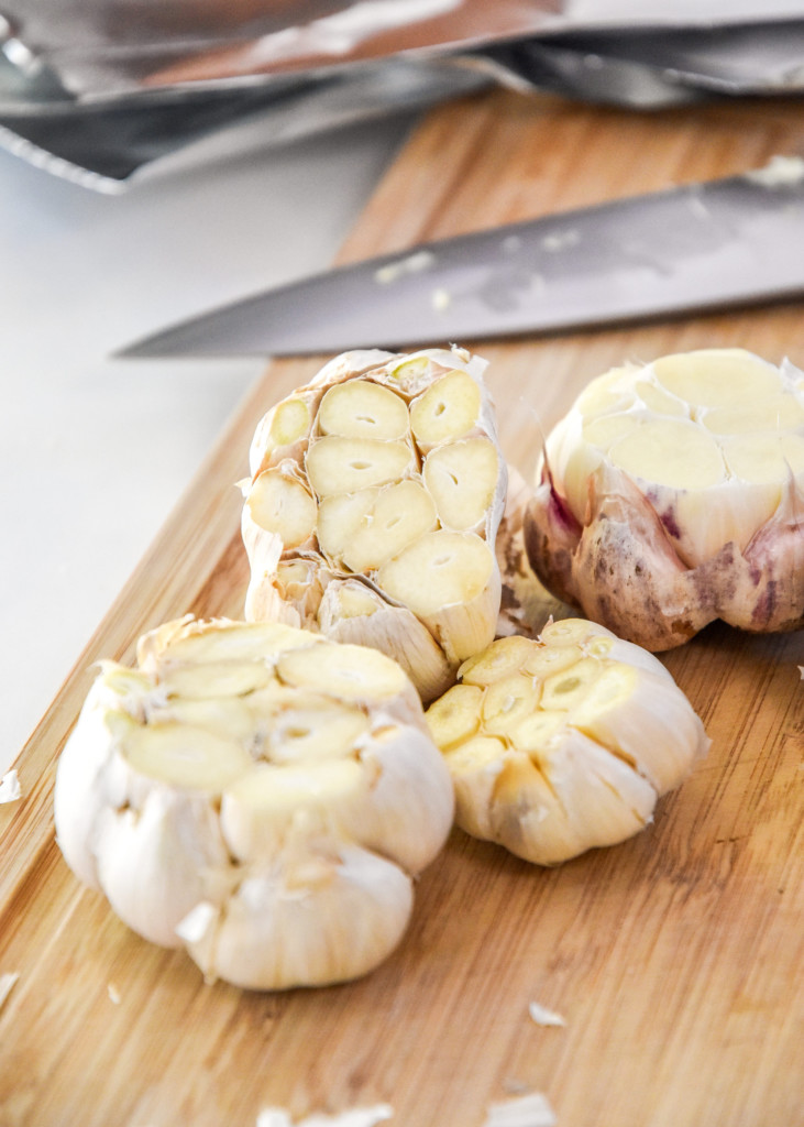 heads of garlic with the top cut off for roasting.