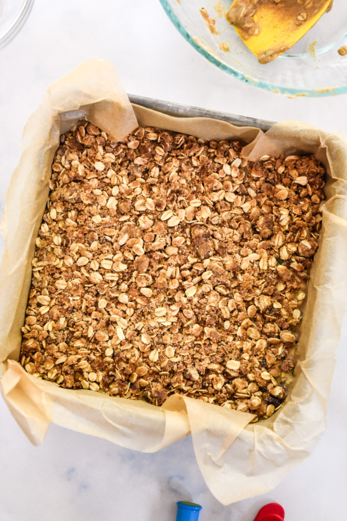 This Cinnamon Raisin Zucchini Coffee Cake is easy to make, seriously delicious, and not-too-sweet! It's a make-ahead friendly breakfast or snack cake made with rolled oats, raisins, one whole zucchini, and a cinnamon crumb topping! pmp.local