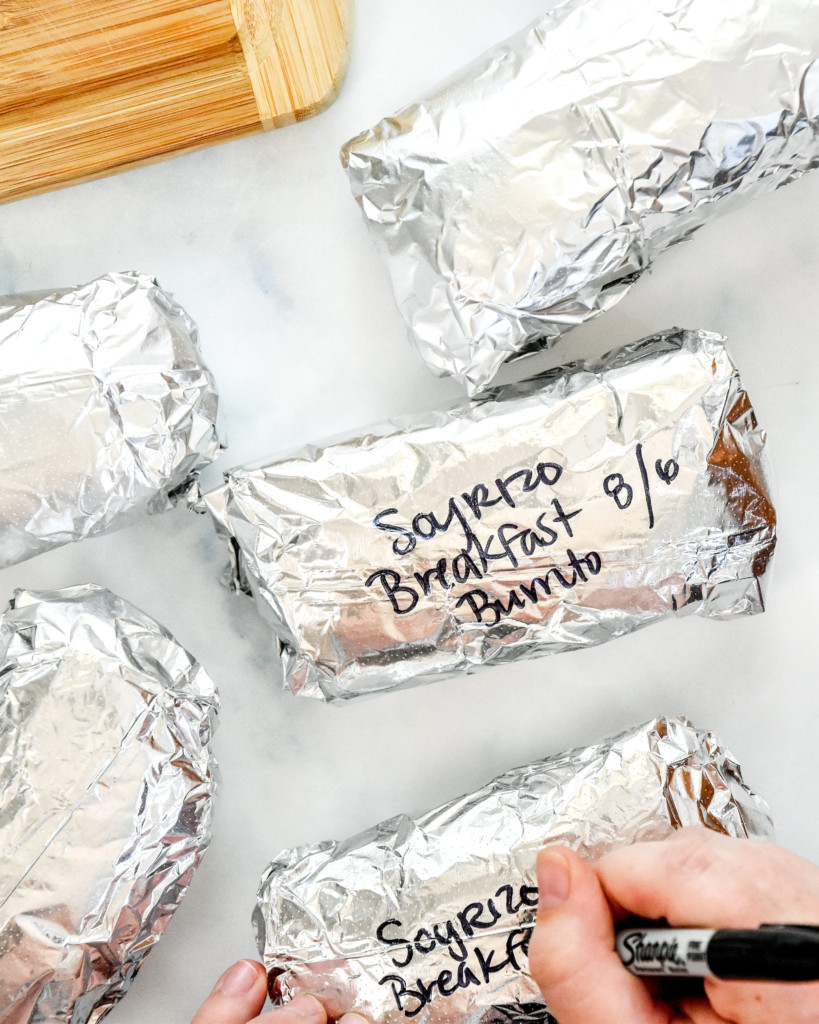 meal prep soy chorizo breakfast burritos wrapped in foil and labeled.