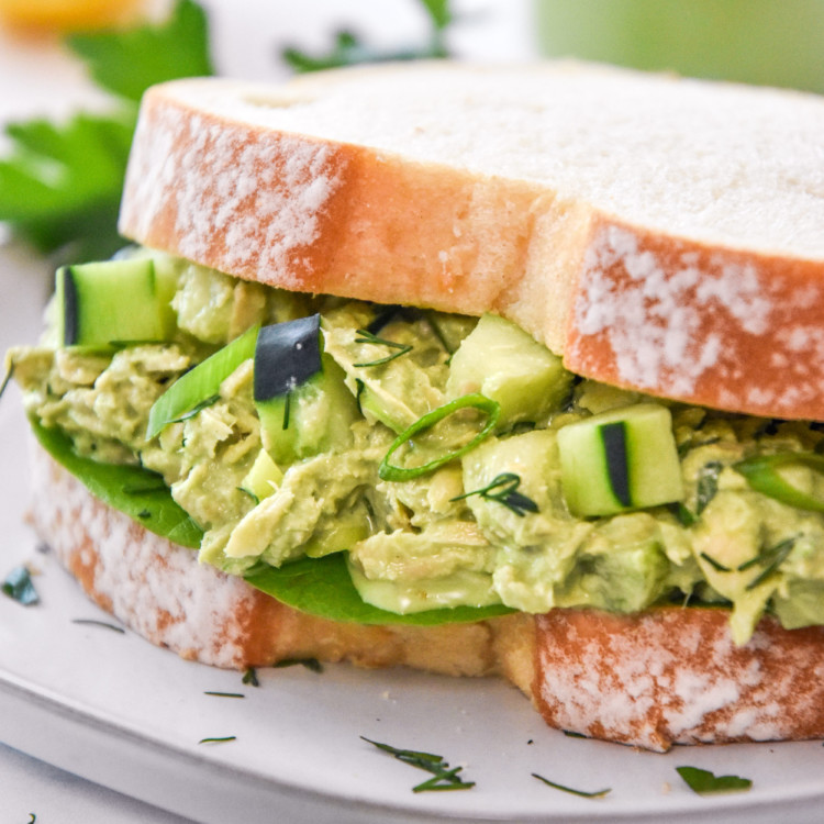 green goddess tuna salad sandwich on white bread.