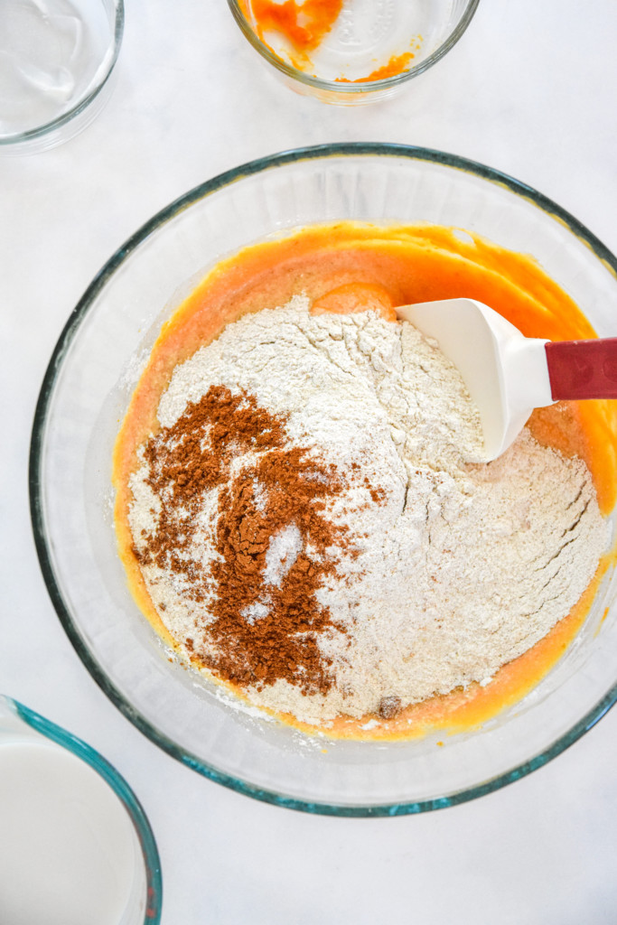 pancake mix and dry ingredients mixing into the wet ingredients for the pancakes.