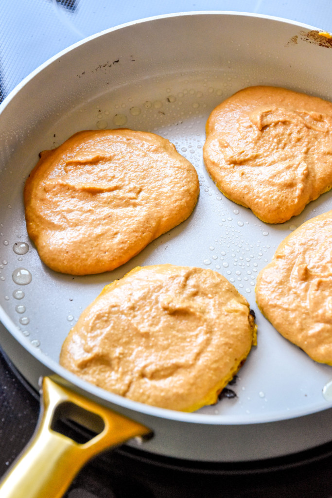 cooking pancakes on a large nonstick pan.