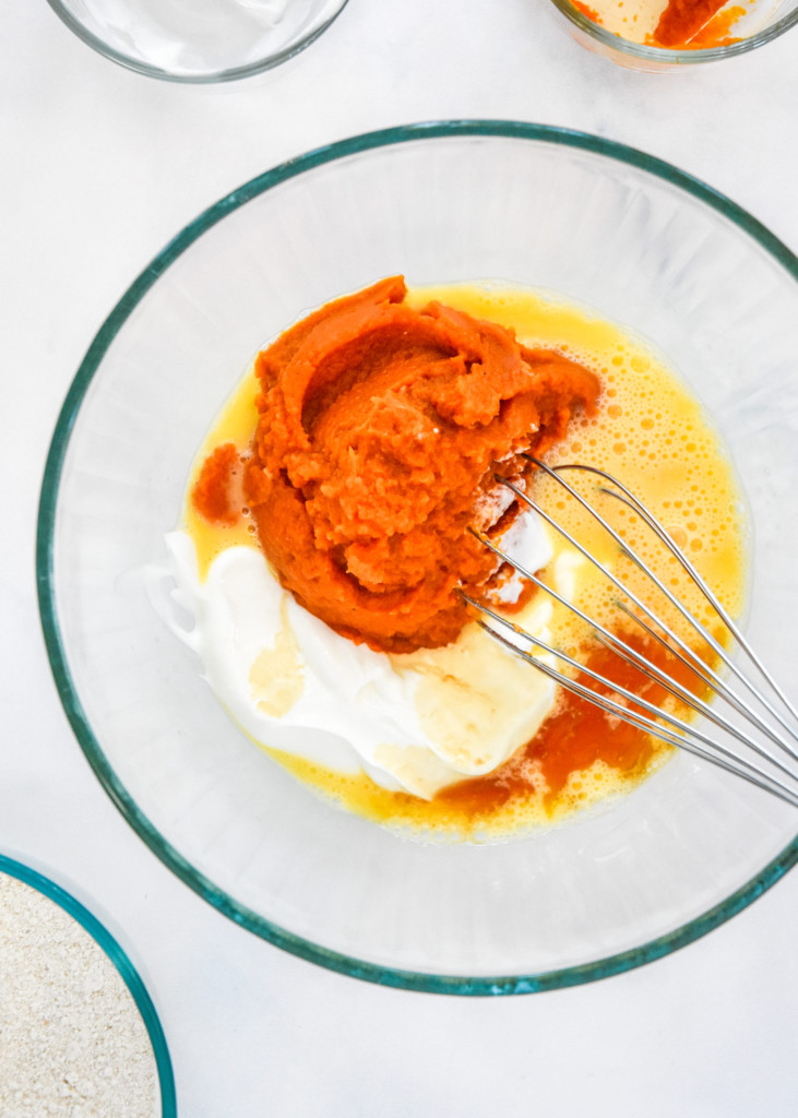 mixing the wet ingredients together in a glass bowl for the pumpkin pie pancakes.