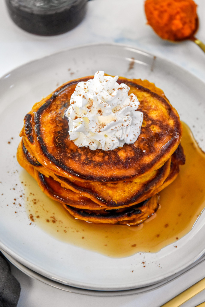 whipped cream on top of pumpkin pie pancakes.