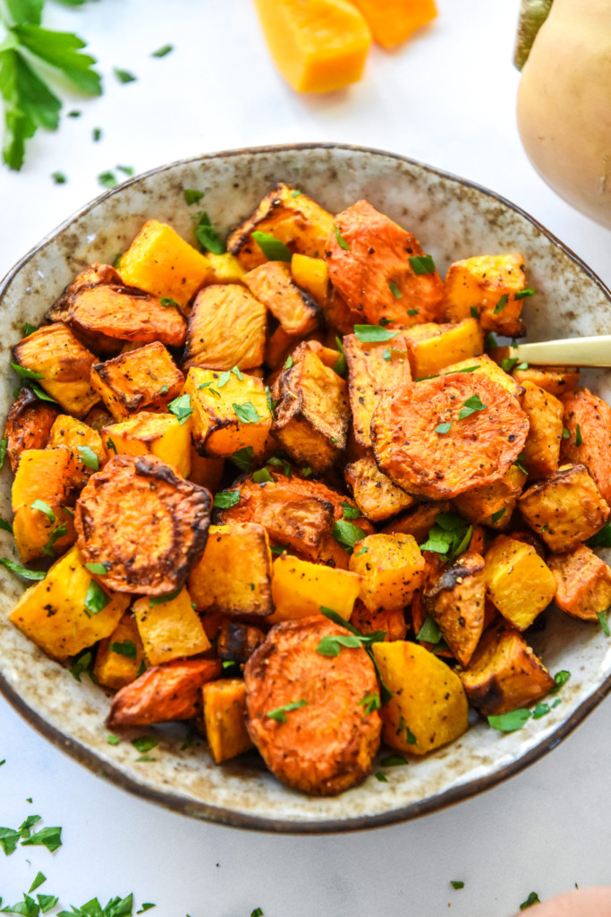 bowl of air fryer roasted fall vegetables with a spoon.