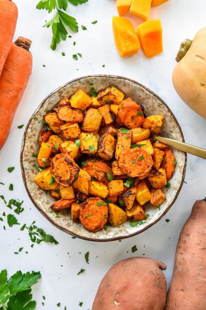 bowl of air fryer roasted fall vegetables with a spoon.