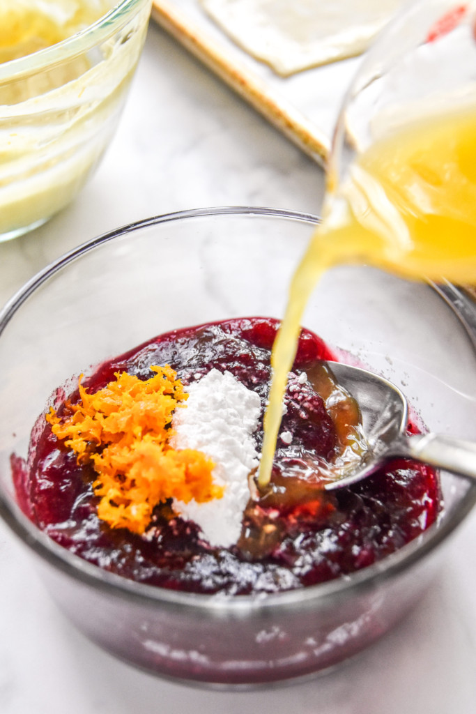 pouring orange juice into the cranberry sauce mixture for the leftover cranberry sauce cheese danish recipe.