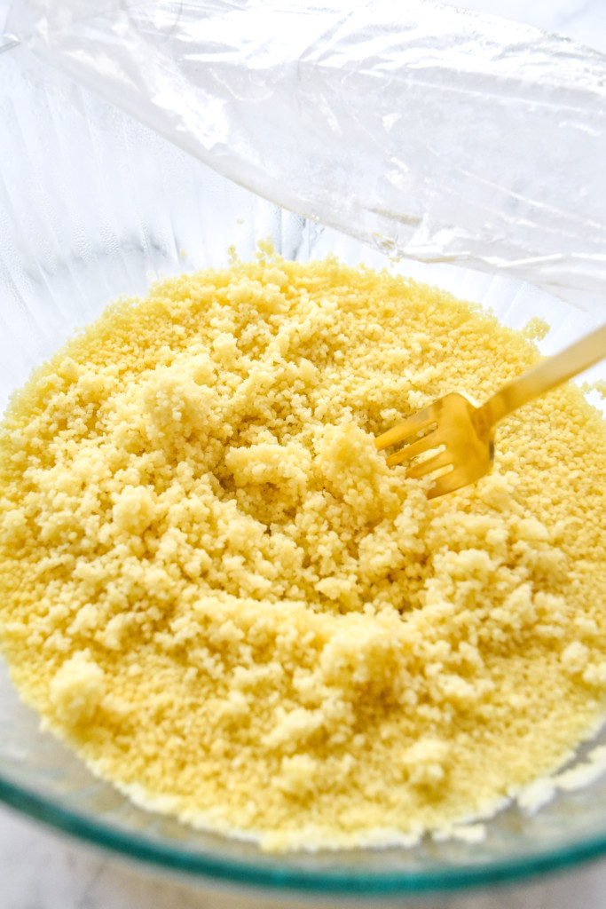 cooked and fluffed couscous in a glass bowl for the roasted butternut squash couscous salad.