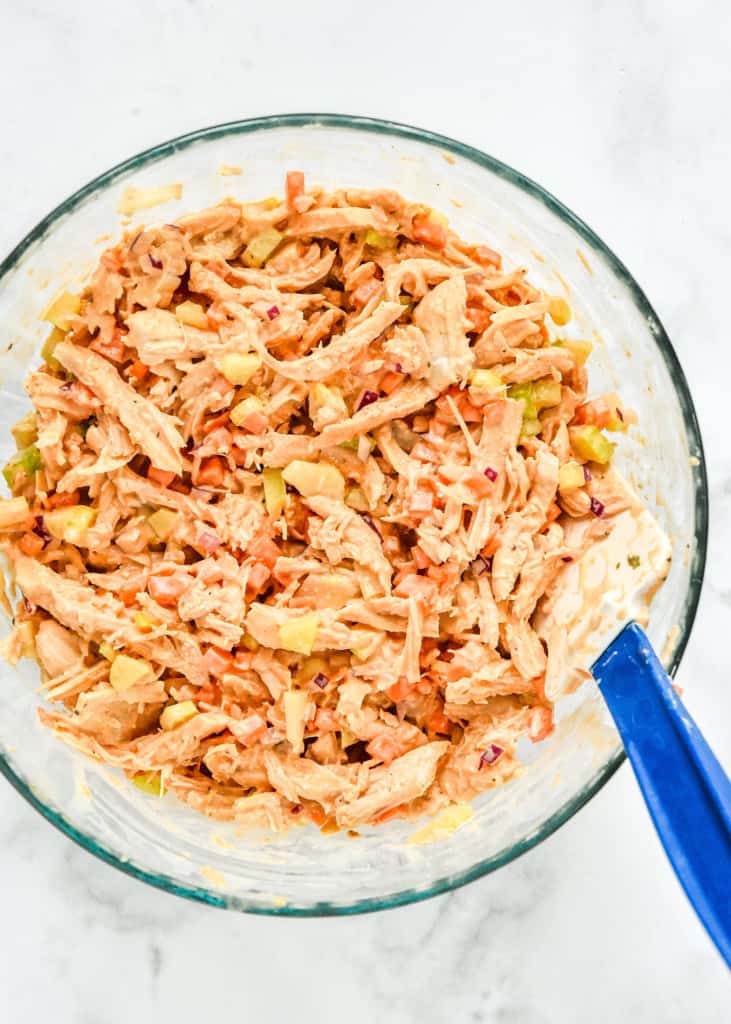 mixed up easy buffalo chicken salad in a glass mixing bowl. 