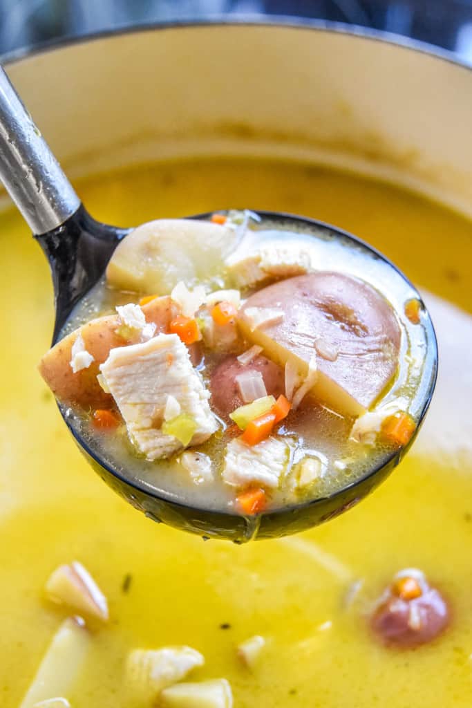spoonful of simple red potato chicken soup after cooking in a dutch oven.