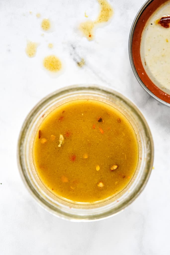 lemon oil dressing in a glass mason jar.