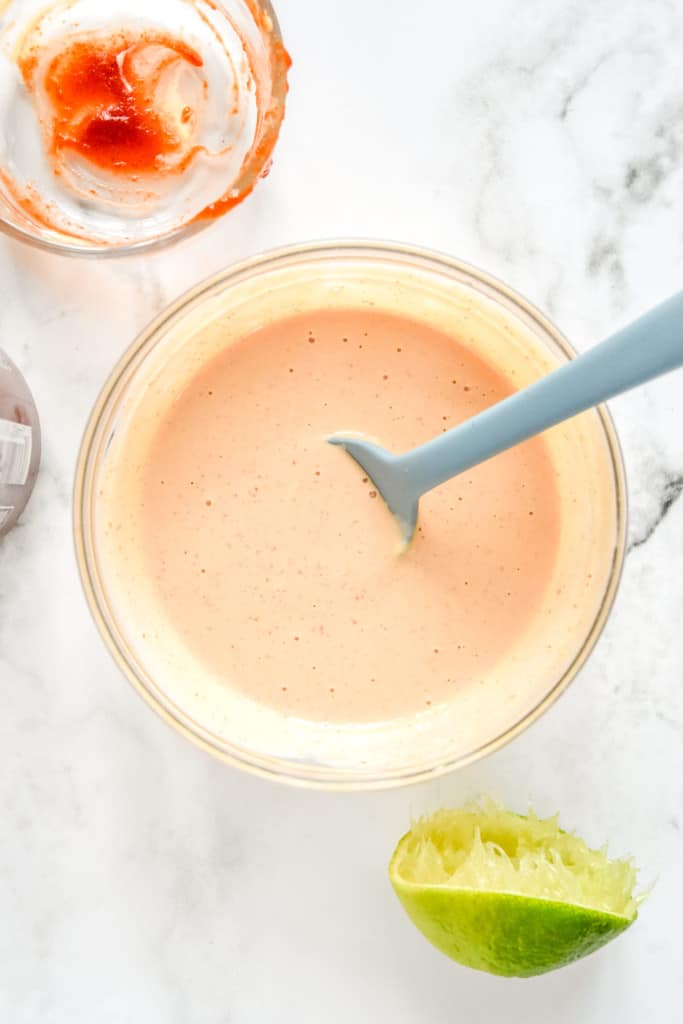 spicy mayo mixed up in a glass bowl for the banh mi inspired meal prep bowls.