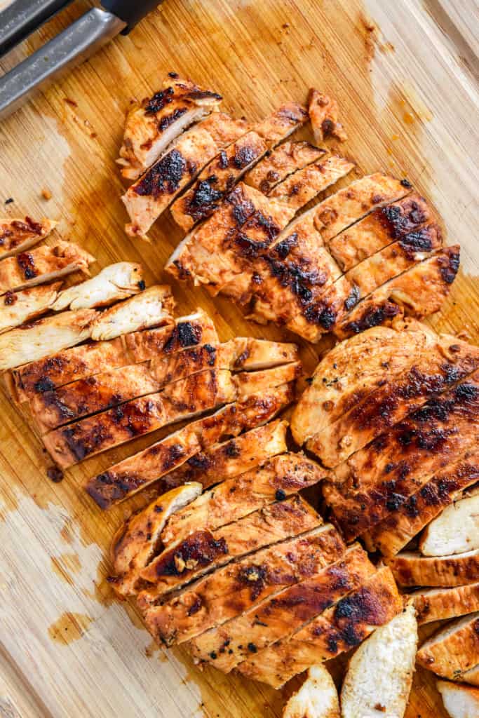 cooked and sliced chipotle lime chicken on a cutting board.
