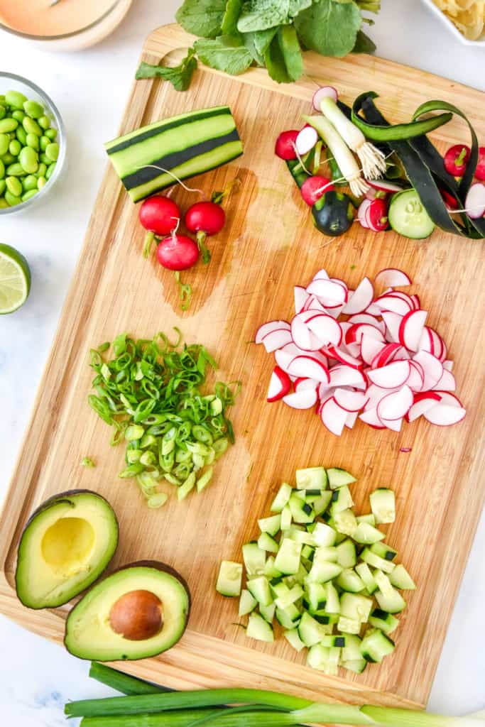 prepping and chopping veggies for easy smoked salmon rice bowls.