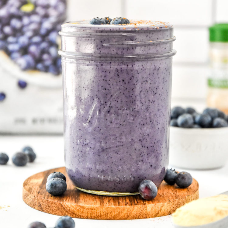 peanut butter powder blueberry cinnamon smoothie with fresh blueberries.