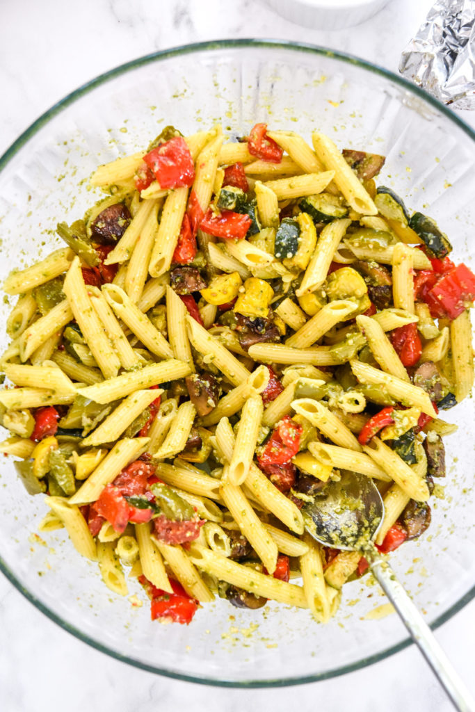 mixed roasted veggie pesto pasta in a large mixing bowl.