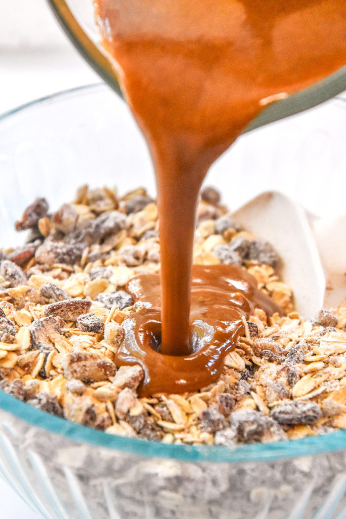 pouring a wet ingredient mixture into the dry ingredients bowl.