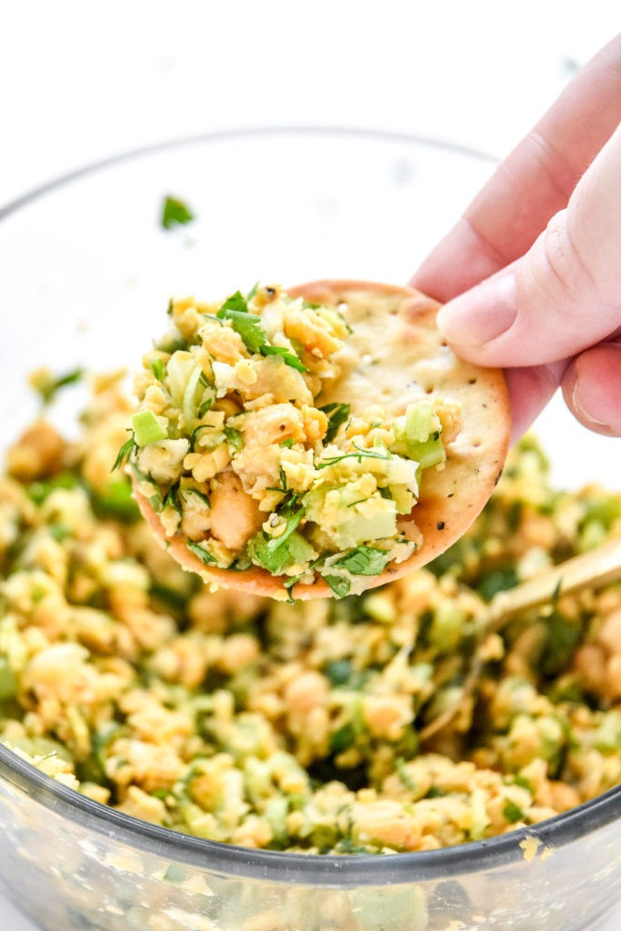 herby lemon mashed chickpea salad on a cracker.