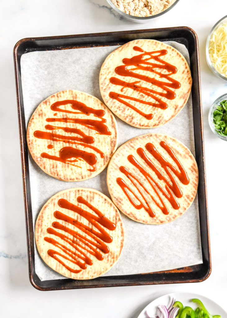 barbecue sauce drizzled on pitas to make pizzas.