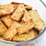 homemade everything but the bagel crackers in a glass bowl.
